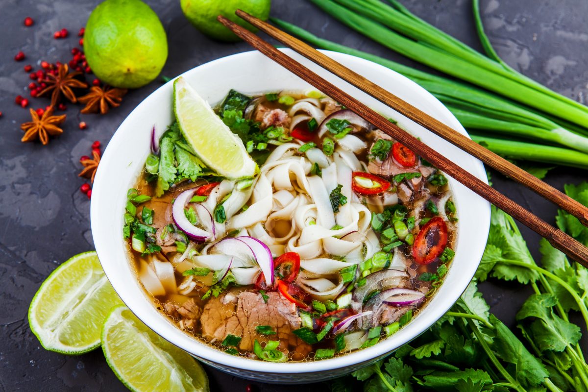 Vietnamese Beef Noodle Soup Pho Bo with beef on dark background